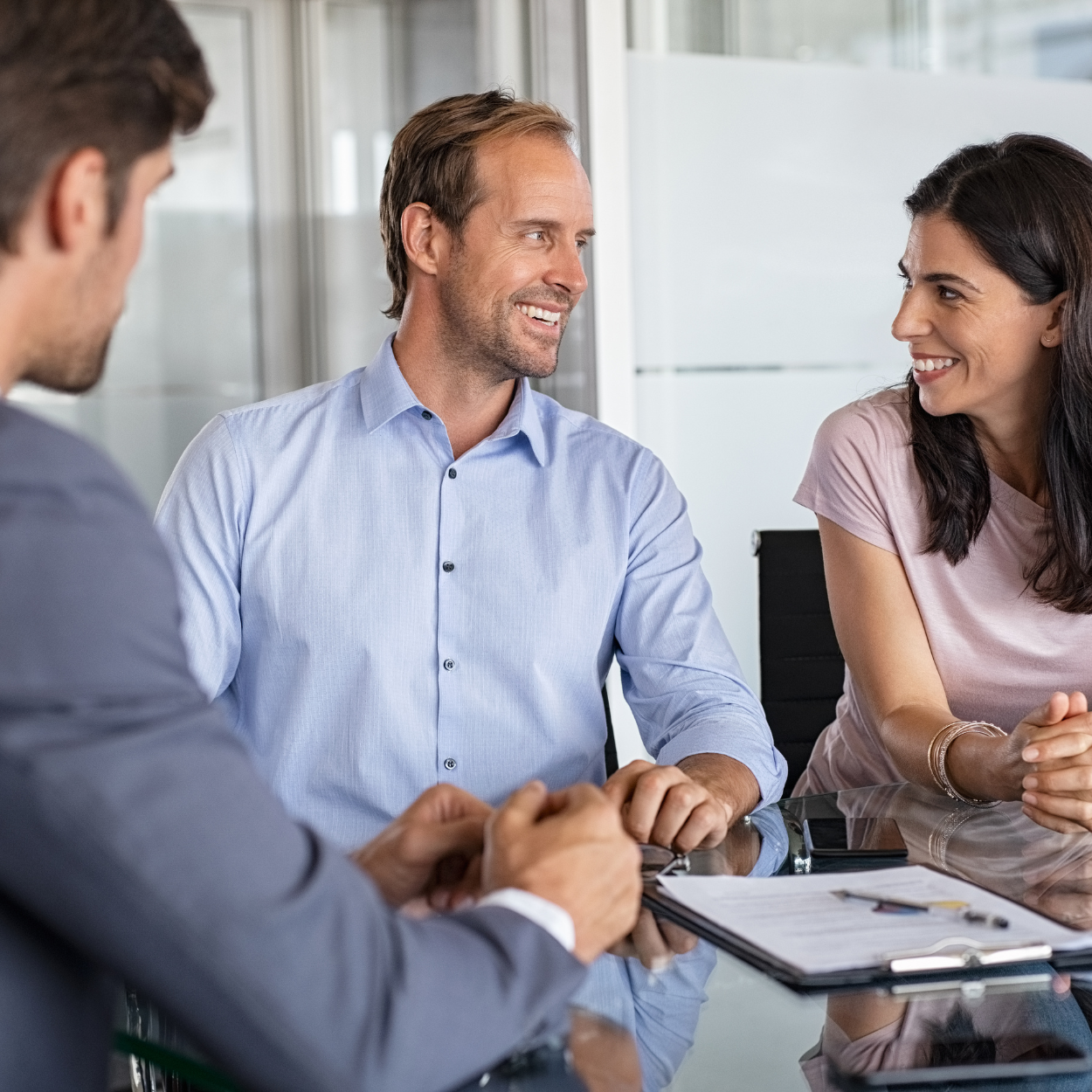 A man and woman talking to an investor.